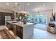 Open-concept living space boasts a kitchen island, dining area, and cozy seating with natural light at 7330 E Vista Bonita Dr, Scottsdale, AZ 85255