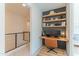 Upstairs office with built-in shelves, desk, and chair, with neutral color scheme and open to hallway at 7330 E Vista Bonita Dr, Scottsdale, AZ 85255