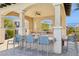 Outdoor kitchen with a large granite counter, stainless steel grill, and seating for entertaining at 7330 E Vista Bonita Dr, Scottsdale, AZ 85255