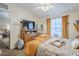 Comfortable bedroom with large window, ceiling fan, and a dresser at 7807 E Main St # H-27, Mesa, AZ 85207
