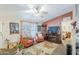 Inviting living room with comfortable seating, fireplace, and views into the bedroom at 7807 E Main St # H-27, Mesa, AZ 85207