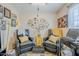 Cozy sitting area with two leather chairs, decorative pillows, accent table, and unique wall art at 7807 E Main St # H-27, Mesa, AZ 85207