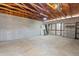 Unfinished basement featuring exposed wooden beams, cement floors, and cinderblock walls at 818 W Earll Dr, Phoenix, AZ 85013