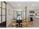 Dining room with a modern table, chairs, and french doors leading to the backyard at 818 W Earll Dr, Phoenix, AZ 85013