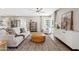 Bright living room with modern furnishings, hardwood floors, and large windows at 818 W Earll Dr, Phoenix, AZ 85013