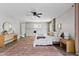 Bright main bedroom features a ceiling fan, stylish rug, and natural light at 818 W Earll Dr, Phoenix, AZ 85013