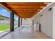 Cozy covered patio features a wood ceiling with string lights and access to the backyard and its artificial lawn at 818 W Earll Dr, Phoenix, AZ 85013