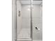 The modern tiled shower includes a glass door, recessed shelf, and honeycomb floor at 818 W Earll Dr, Phoenix, AZ 85013