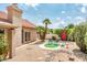 Charming backyard with desert landscaping, a seating area, and a beautiful red umbrella at 8977 E Ludlow Dr, Scottsdale, AZ 85260