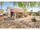 Desert-landscaped backyard featuring a covered patio, mature landscaping, and peaceful ambiance at 8977 E Ludlow Dr, Scottsdale, AZ 85260