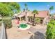 Backyard featuring desert landscaping, a red umbrella, and a cozy seating area at 8977 E Ludlow Dr, Scottsdale, AZ 85260