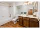 Bathroom featuring tub-shower combo with white tiling and a wood vanity sink at 8977 E Ludlow Dr, Scottsdale, AZ 85260