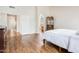Bedroom featuring wood floors, walk in and arch doorways, and plenty of natural light at 8977 E Ludlow Dr, Scottsdale, AZ 85260