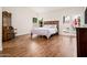 Primary bedroom with wood floors, natural light, and french doors at 8977 E Ludlow Dr, Scottsdale, AZ 85260