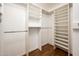 Walk-in closet with custom shelving and wood-look floors at 8977 E Ludlow Dr, Scottsdale, AZ 85260