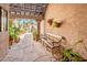 Charming covered courtyard with stone flooring, seating, and potted plants at 8977 E Ludlow Dr, Scottsdale, AZ 85260