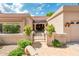 Inviting front entrance with desert landscaping and decorative stone pathway leading to the front door at 8977 E Ludlow Dr, Scottsdale, AZ 85260