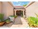 Charming front entrance with stone pathway, potted plants, and seating area at 8977 E Ludlow Dr, Scottsdale, AZ 85260