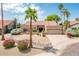 Charming single-story home with desert landscaping, mature palm trees, and a two-car garage at 8977 E Ludlow Dr, Scottsdale, AZ 85260