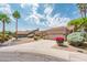 Inviting single-story home with desert landscaping, mature palm trees, and a two-car garage at 8977 E Ludlow Dr, Scottsdale, AZ 85260