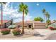 Charming single-story home with desert landscaping, mature palm trees, and a two-car garage at 8977 E Ludlow Dr, Scottsdale, AZ 85260