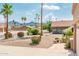 Landscaped front yard with colorful plants, desert landscaping, mature palm trees and mountain views at 8977 E Ludlow Dr, Scottsdale, AZ 85260