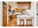 Well-designed kitchen with wood cabinets, modern appliances, breakfast bar, and functional layout at 8977 E Ludlow Dr, Scottsdale, AZ 85260