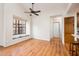Bright living room featuring wood floors, a large window seat, and a ceiling fan at 8977 E Ludlow Dr, Scottsdale, AZ 85260