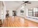Spacious living room with vaulted ceilings, wood floors, large windows, and natural light at 8977 E Ludlow Dr, Scottsdale, AZ 85260