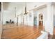 Open living space featuring wood floors, expansive mirror, arched doorways, and modern lighting at 8977 E Ludlow Dr, Scottsdale, AZ 85260