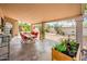 Covered patio with an outdoor dining table and lush landscaping at 8977 E Ludlow Dr, Scottsdale, AZ 85260