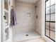 New shower with gray tiling, a shower window, and a built-in niche for toiletries at 8977 E Ludlow Dr, Scottsdale, AZ 85260