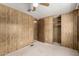 Bedroom featuring carpet, wood paneling, closet, and ceiling fan at 9302 E Broadway Rd # 45, Mesa, AZ 85208