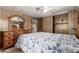 Bedroom featuring carpet, wood paneled walls, and wood furniture at 9302 E Broadway Rd # 45, Mesa, AZ 85208