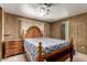 Bedroom featuring wood paneled walls, carpet, and furniture at 9302 E Broadway Rd # 45, Mesa, AZ 85208