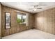 Bedroom with wood paneling, window providing natural light, and plush carpeting at 9302 E Broadway Rd # 45, Mesa, AZ 85208