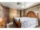 Bedroom featuring wood paneled walls, carpet, and ceiling fan at 9302 E Broadway Rd # 45, Mesa, AZ 85208