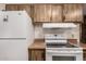 View of white appliances and wood cabinets in the kitchen at 9302 E Broadway Rd # 45, Mesa, AZ 85208