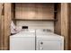 Laundry room with side by side washer and dryer and custom cabinetry at 9302 E Broadway Rd # 45, Mesa, AZ 85208