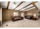 Spacious living room featuring wood paneling, ceiling beams and neutral colored carpeting at 9302 E Broadway Rd # 45, Mesa, AZ 85208