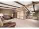 Open-concept living room with wood paneling, ceiling beams and neutral carpeting at 9302 E Broadway Rd # 45, Mesa, AZ 85208