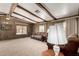 Comfortable living room featuring wood paneling, ceiling beams and neutral carpeting at 9302 E Broadway Rd # 45, Mesa, AZ 85208