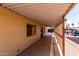 Covered patio featuring siding, a window, and access to both the front and back of property at 9302 E Broadway Rd # 45, Mesa, AZ 85208
