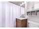 Bathroom featuring vanity with marble countertop, a wood cabinet, and a shower with white tiled walls at 9603 N 1St Ave, Phoenix, AZ 85021