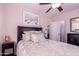 This bedroom features an ample bed with decorative pillows, dark furniture and a ceiling fan at 9603 N 1St Ave, Phoenix, AZ 85021