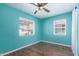 This bedroom has two windows, hardwood floors, and light turquoise walls at 9603 N 1St Ave, Phoenix, AZ 85021