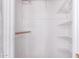 A simple white closet with white walls and metal shelving on the back wall at 9603 N 1St Ave, Phoenix, AZ 85021