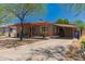 Cozy home with a front yard featuring native trees, a covered patio, and a convenient carport at 9603 N 1St Ave, Phoenix, AZ 85021