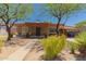 Charming single-story home featuring desert landscaping and a covered front porch with cozy seating at 9603 N 1St Ave, Phoenix, AZ 85021