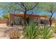 Single-story home with desert landscaping, offering shade with mature trees and covered porch at 9603 N 1St Ave, Phoenix, AZ 85021